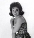 Karyn_Kupcinet_posing_for_camera_gingham_dress.jpg