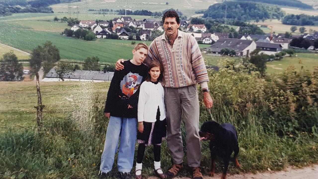 Salt Creek backpacker kidnapper Roman Heinze, daughter Kendehl and son Josh, embrace on the side of a road during a family trip to Germany in 1997. Picture: Supplied