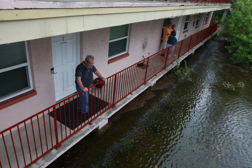 Ken Kruse looks out at the flood waters from Hurricane Idalia surrounding his apartment complex on August 30, 2023, in Tarpon Springs, Florida. / Credit: / Getty Images