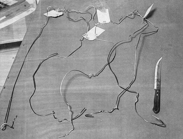 These five coat hangers and a 12-inch knife were used in the slayings of Mary Petry and William Sproat. Columbus police displayed them to the media on March 3, 1970, two days after the couple’s bodies were found. [Dispatch file photo]