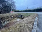 Drain at Webster Rd entrance of Stoneybrook that leads across the street into the Storage lot.jpg