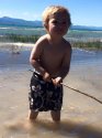 Photo of DeOrr in shorts in the water holding a stick.jpg