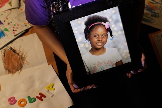 HAYWARD, CALIFORNIA - June 07: Emerald Johnson, aunt of Sophia Mason, an 8-year-old girl from Hayward whose mother and mother's boyfriend stand accused of murdering her, poses for a portrait with a photo of Mason, her drawings and school work at Johnson’s home in Hayward, Calif., on Tuesday, June 7, 2022. (Dai Sugano/Bay Area News Group)