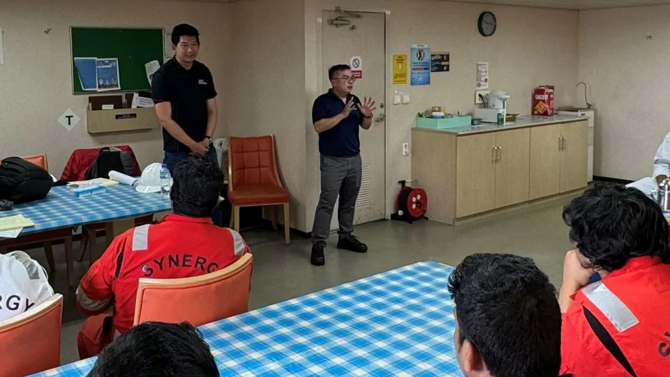 From left: Bro Chen Chuanyi, executive secretary of the Singapore Organisation of Seamen, and Gwee Guo Duan, assistant general secretary of the Singapore Maritime Officers’ Union, speak with seamen aboard the Dali on April 24, four weeks ater the cargo ship crashed into Balitmore's Key Bridge. - Singapore Maritime Officers’ Union/Singapore Organisation of Seamen/ITF