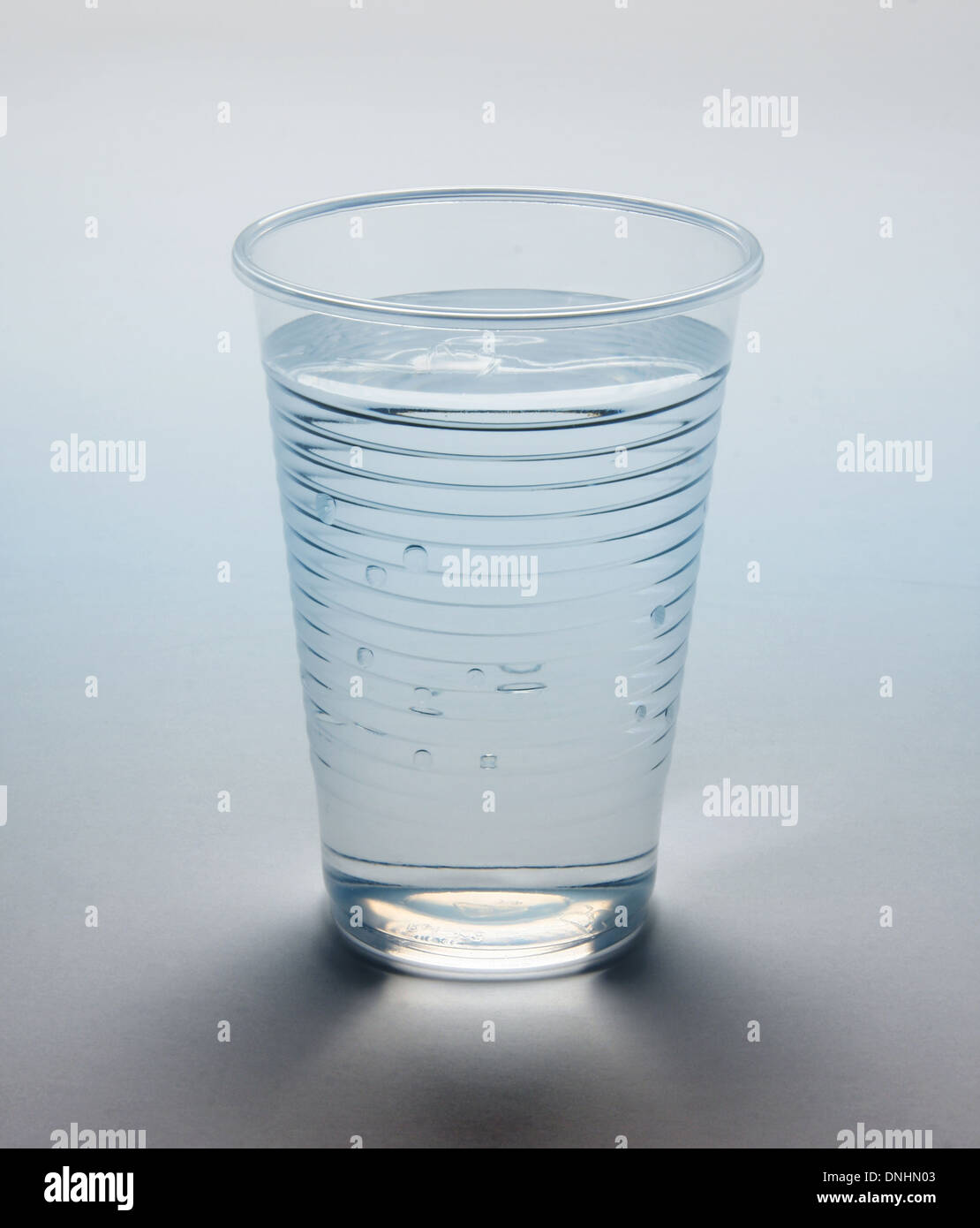 a-glass-of-water-in-a-plastic-cup-back-lit-with-light-shining-through-DNHN03.jpg