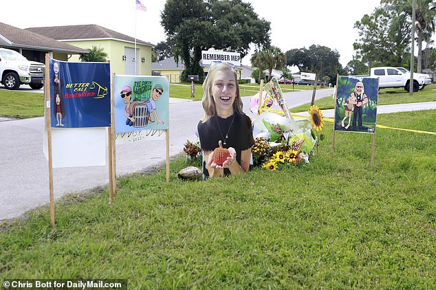 49290275-10101343-Protestors_are_working_to_keep_up_a_tribute_to_Gabby_Petito_on_t-a-105_1634508314857.jpg