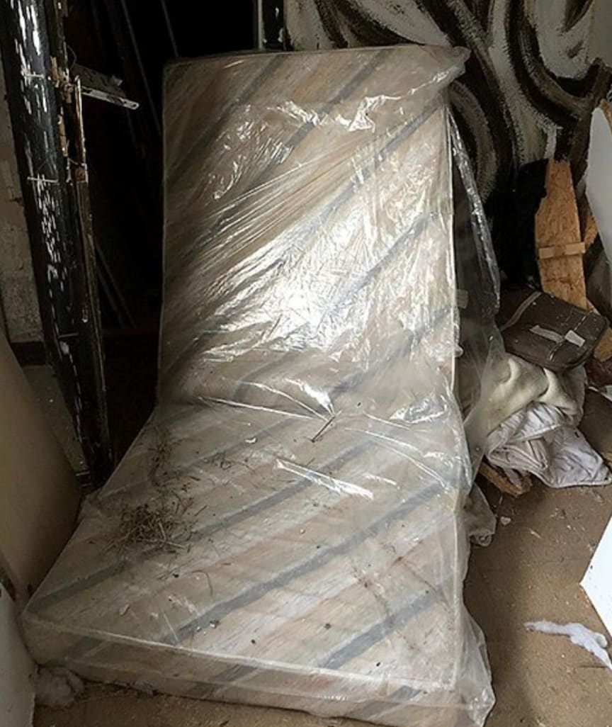 In one room, investigators found a shrink-wrapped mattress and a makeshift toilet
