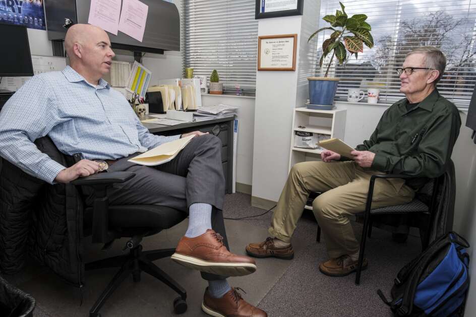 Investigator Matt Denlinger speaks with Retired Cedar Rapids Police Lieutenant Kenneth Washburn in Denlinger’s office at the Cedar Rapids Police station in Mount Vernon, Iowa on Tuesday, Nov. 21, 2023. (Nick Rohlman/The Gazette)