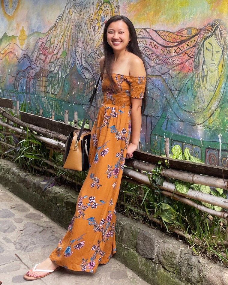 Nancy Ng poses for a photo in front of a mural in Guatemala.