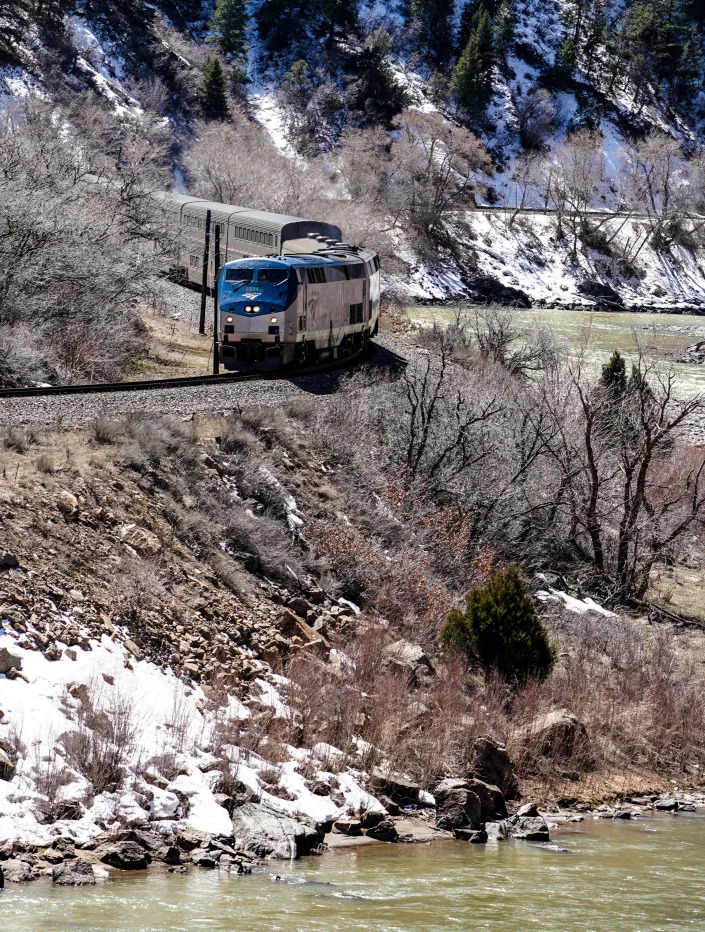 Amtrak's California Zephyr train climbs out of Glenwood Springs, Colorado, through Glenwood Canyon, alongside the Colorado River, on its way east to Denver.