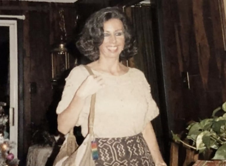 A young woman with her hair in a short curled style smiles at something off-camera, she's in a skirt and white blouse. A young woman with her hair in a short curled style smiles at something off-camera, she's in a skirt and white blouse.